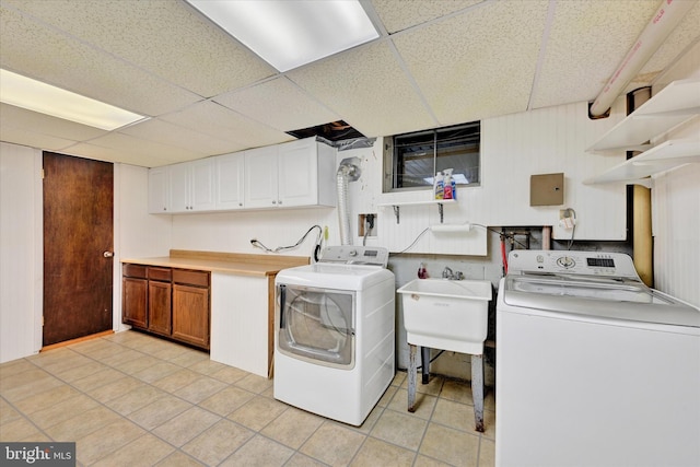 22 Woodholme Village Ct, Baltimore, MD 21208 - washroom with cabinet space, light tile patterned floors, and separate washer and dryer