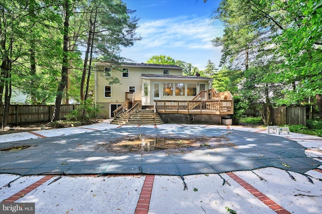 22 Woodholme Village Ct, Baltimore, MD 21208 - rear view of property featuring a wooden deck, stairway, and a patio area