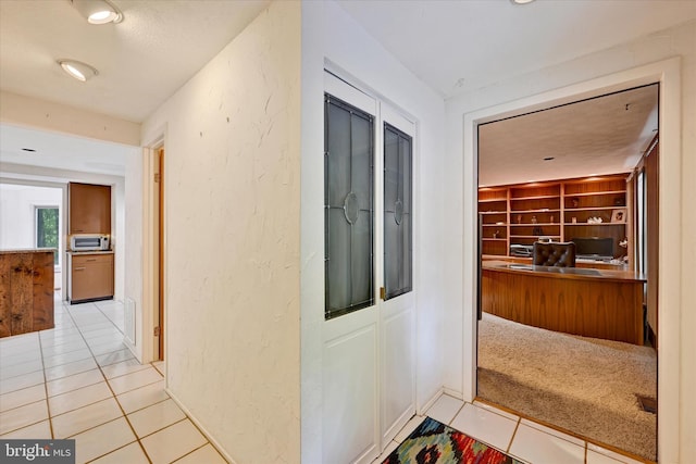 22 Woodholme Village Ct, Baltimore, MD 21208 - corridor featuring light tile patterned floors and a textured wall