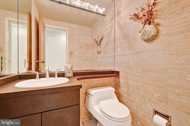 22 Woodholme Village Ct, Baltimore, MD 21208 - bathroom featuring vanity, toilet, and tile walls