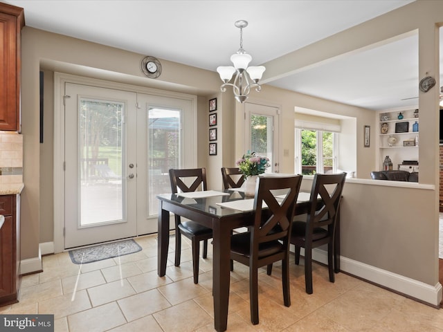 6805 Spout Ln, Fairfax Station, VA 22039 - dining space with a chandelier, french doors, baseboards, and light tile patterned floors