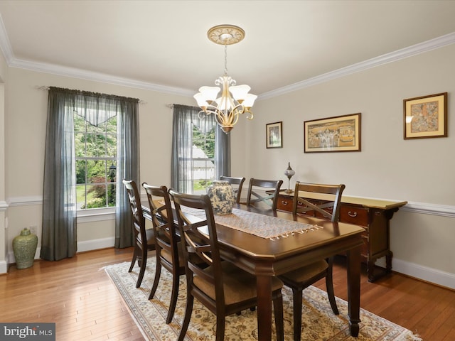 6805 Spout Ln, Fairfax Station, VA 22039 - dining area featuring a chandelier, crown molding, light wood finished floors, and baseboards