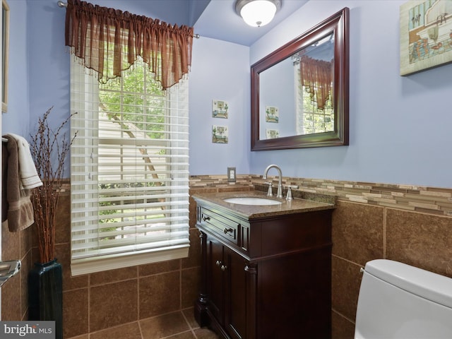 6805 Spout Ln, Fairfax Station, VA 22039 - bathroom with vanity, tile walls, healthy amount of natural light, toilet, and wainscoting