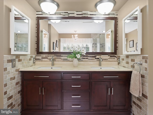 6805 Spout Ln, Fairfax Station, VA 22039 - bathroom with double vanity, a chandelier, backsplash, tile walls, and a shower