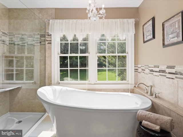6805 Spout Ln, Fairfax Station, VA 22039 - bathroom with a freestanding tub, tile walls, tiled shower, and a chandelier