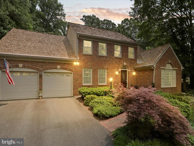 6805 Spout Ln, Fairfax Station, VA 22039 - colonial house with a garage, brick siding, and driveway