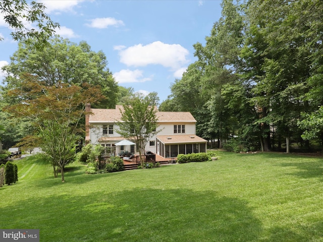 6805 Spout Ln, Fairfax Station, VA 22039 - rear view of property featuring a sunroom, a deck, a lawn, and a chimney
