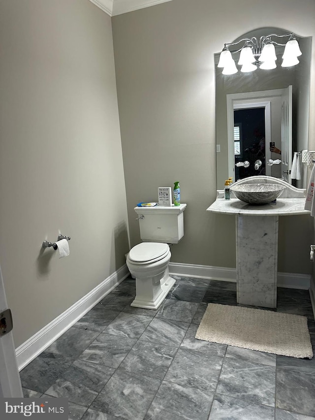 265 N Cologne Ave, Egg Harbor City, NJ 08215 - half bathroom with toilet, baseboards, crown molding, vanity, and marble look tiles