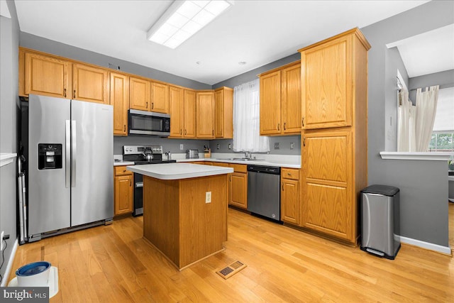 3765 Glebe Meadow Way, Edgewater, MD 21037 - kitchen featuring stainless steel appliances, light wood finished floors, light countertops, a kitchen island, and a sink