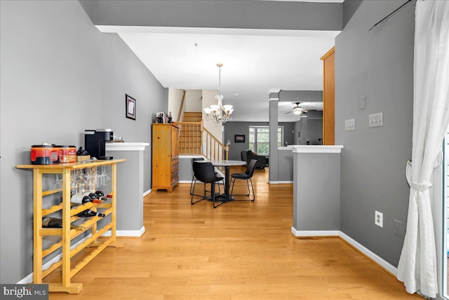 3765 Glebe Meadow Way, Edgewater, MD 21037 - dining area with ceiling fan, light wood finished floors, a chandelier, baseboards, and stairway