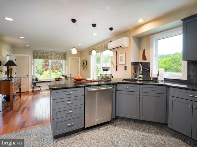 442 Old Eagle School Rd, Wayne, PA 19087 - kitchen featuring stainless steel dishwasher, a sink, an AC wall unit, gray cabinets, and a peninsula