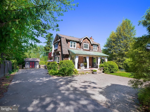 442 Old Eagle School Rd, Wayne, PA 19087 - shingle-style home with driveway, covered porch, a gambrel roof, metal roof, and a chimney