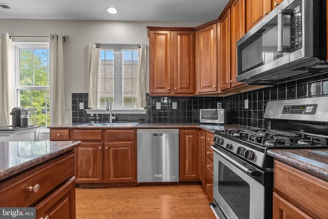 22 Goldfields Ave, Langhorne, PA 19047 - kitchen featuring appliances with stainless steel finishes, a sink, brown cabinetry, recessed lighting, and light wood-style floors