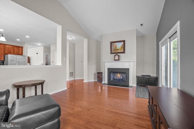 22 Goldfields Ave, Langhorne, PA 19047 - living area featuring light wood-type flooring, a warm lit fireplace, baseboards, recessed lighting, and lofted ceiling