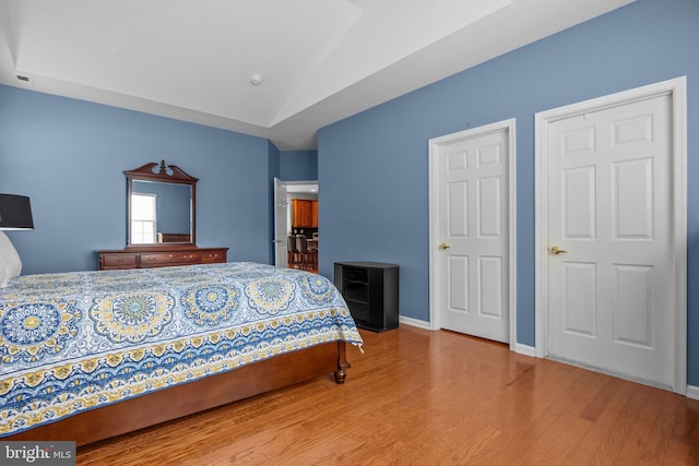 22 Goldfields Ave, Langhorne, PA 19047 - bedroom featuring wood finished floors, lofted ceiling, and baseboards