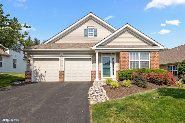 22 Goldfields Ave, Langhorne, PA 19047 - view of front facade with brick siding, driveway, and a garage