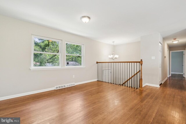 3713 Deming Dr, Suitland, MD 20746 - empty room with a chandelier, wood finished floors, and baseboards
