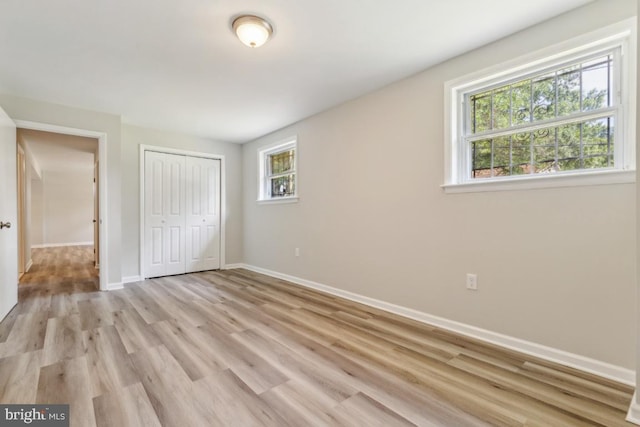 3713 Deming Dr, Suitland, MD 20746 - unfurnished bedroom with baseboards, a closet, and light wood-style flooring