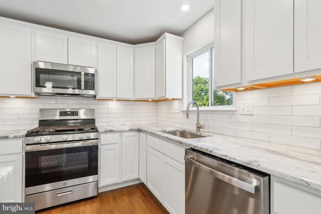 3713 Deming Dr, Suitland, MD 20746 - kitchen with stainless steel appliances, a sink, white cabinets, tasteful backsplash, and recessed lighting