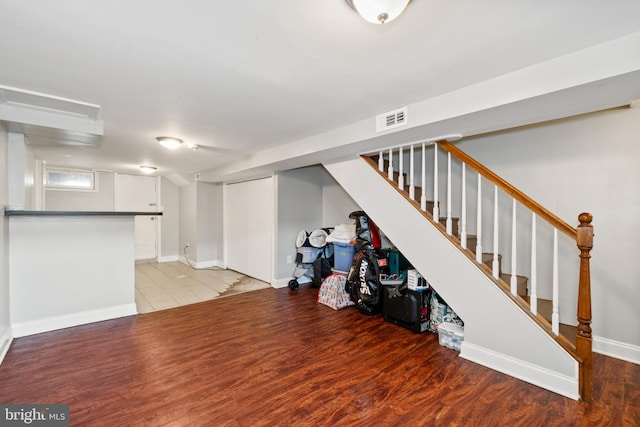 6904 Bank St, Baltimore, MD 21224 - finished basement featuring light wood-type flooring, stairway, and baseboards