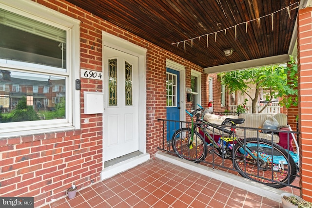 6904 Bank St, Baltimore, MD 21224 - property entrance with covered porch and brick siding