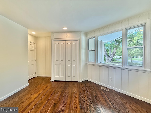 1511 N Ave, Port Norris, NJ 08349 - unfurnished bedroom with baseboards, a closet, dark wood-type flooring, multiple windows, and recessed lighting