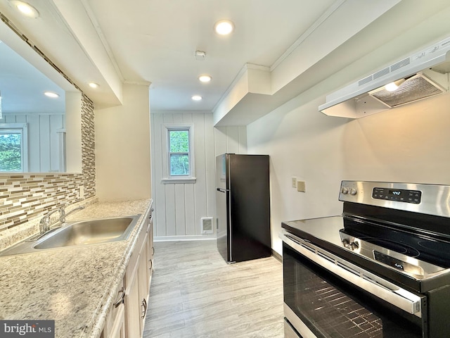 1511 N Ave, Port Norris, NJ 08349 - kitchen featuring stainless steel range with electric cooktop, freestanding refrigerator, a sink, ornamental molding, and extractor fan