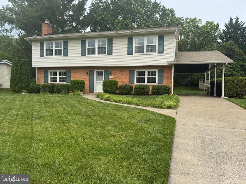 213 Wildman St NE, Leesburg, VA 20176 - view of front of property with a chimney, brick siding, a front yard, an attached carport, and driveway