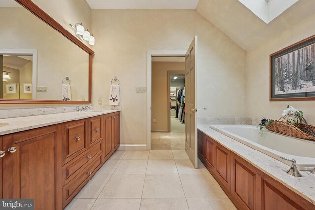 609 Ederer Ln, Ambler, PA 19002 - bathroom featuring double vanity, tile patterned flooring, a garden tub, a skylight, and lofted ceiling