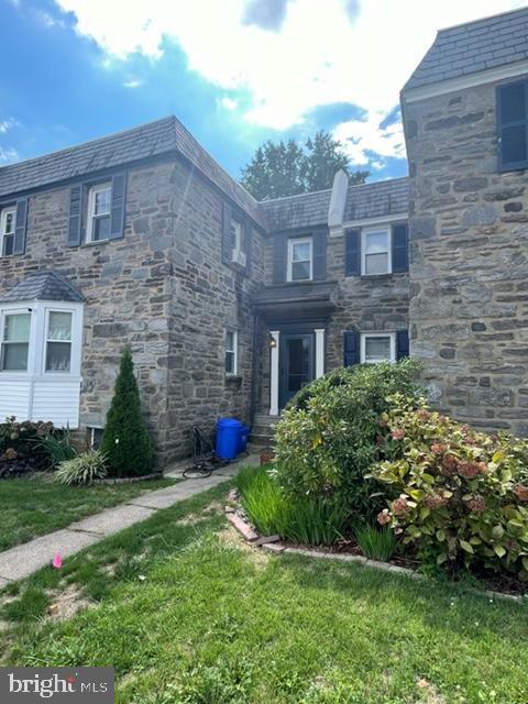 2632 Lenape Rd, Philadelphia, PA 19131 - view of home's exterior with a high end roof, a lawn, and stone siding