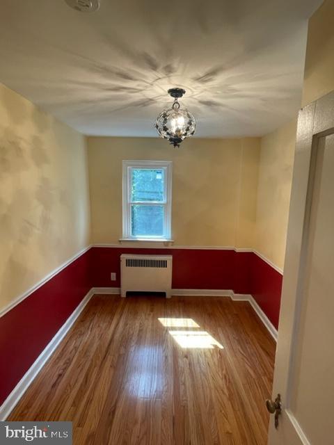 2632 Lenape Rd, Philadelphia, PA 19131 - unfurnished dining area featuring radiator, wood finished floors, and baseboards