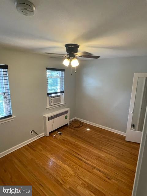 2632 Lenape Rd, Philadelphia, PA 19131 - unfurnished room featuring radiator heating unit, ceiling fan, baseboards, and wood finished floors