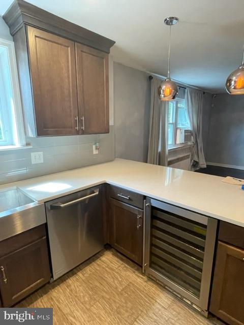 2632 Lenape Rd, Philadelphia, PA 19131 - kitchen featuring dishwasher, beverage cooler, light countertops, and pendant lighting