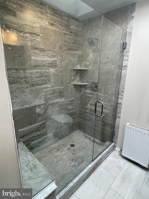 2632 Lenape Rd, Philadelphia, PA 19131 - full bath featuring radiator, a stall shower, and marble look tiles
