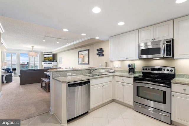 6 7th St Unit 508, Ocean City, MD 21842 - kitchen featuring appliances with stainless steel finishes, a sink, a peninsula, open floor plan, and white cabinets