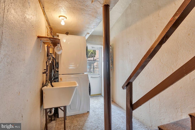 3440 Sheffield Ave, Philadelphia, PA 19136 - laundry room featuring a textured wall, stacked washer / dryer, carpet, and a textured ceiling