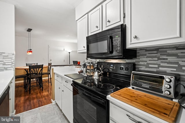 5907L Noblestown Rd Unit 72, Springfield, VA 22152 - kitchen with black appliances, white cabinets, light countertops, and decorative light fixtures