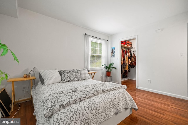 5907L Noblestown Rd Unit 72, Springfield, VA 22152 - bedroom with wood finished floors, a spacious closet, baseboards, and a closet