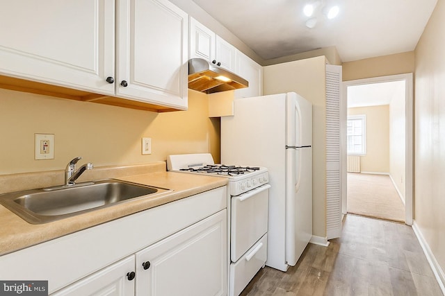 616 Mellon St SE, Washington, DC 20032 - kitchen with white appliances, under cabinet range hood, a sink, and white cabinetry