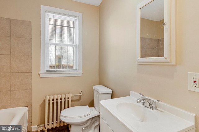 616 Mellon St SE, Washington, DC 20032 - bathroom featuring radiator heating unit, toilet, and vanity