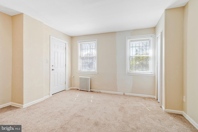 616 Mellon St SE, Washington, DC 20032 - spare room with radiator heating unit, carpet flooring, and baseboards