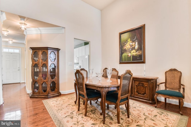 7207 Ivy Bank Rd, Laurel, MD 20707 - dining room with light wood-style floors, baseboards, and crown molding