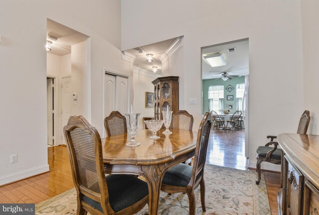 7207 Ivy Bank Rd, Laurel, MD 20707 - dining area featuring ornamental molding, light wood-type flooring, baseboards, and ceiling fan