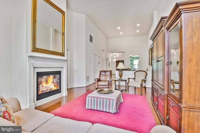 7207 Ivy Bank Rd, Laurel, MD 20707 - living area with wood finished floors, a glass covered fireplace, and recessed lighting