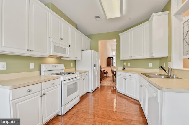 7207 Ivy Bank Rd, Laurel, MD 20707 - kitchen with white appliances, a sink, white cabinets, and light wood finished floors