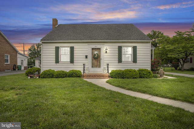 451 C St, Carlisle, PA 17013 - view of front of home with a chimney, a lawn, and a shingled roof