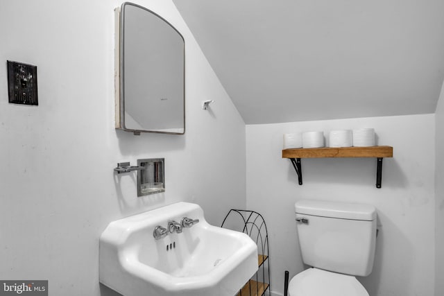 451 C St, Carlisle, PA 17013 - half bathroom featuring a sink, toilet, and lofted ceiling