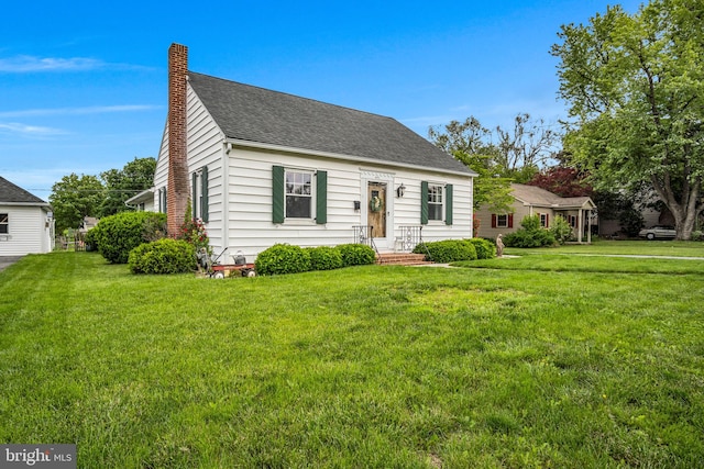 451 C St, Carlisle, PA 17013 - new england style home featuring a chimney, a front yard, and roof with shingles