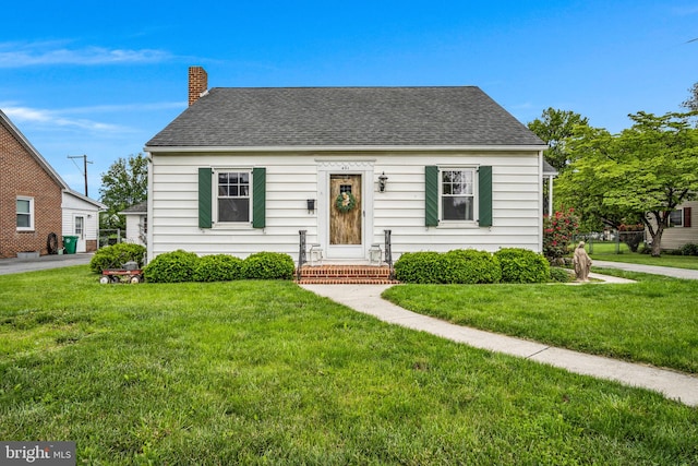451 C St, Carlisle, PA 17013 - view of front of home with a front yard, a chimney, and roof with shingles