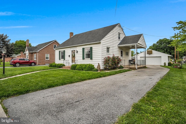 451 C St, Carlisle, PA 17013 - view of front facade featuring an outdoor structure, a detached garage, a front yard, and a shingled roof